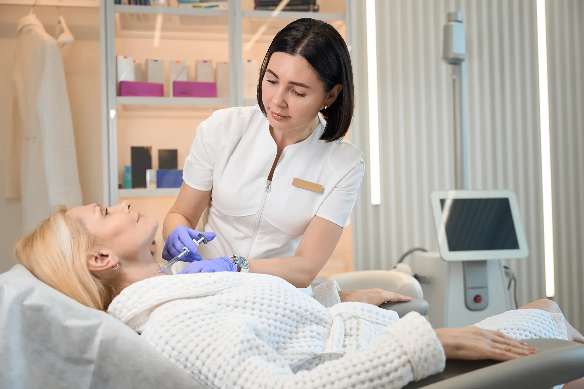 nurse administrating botox treatment with patient